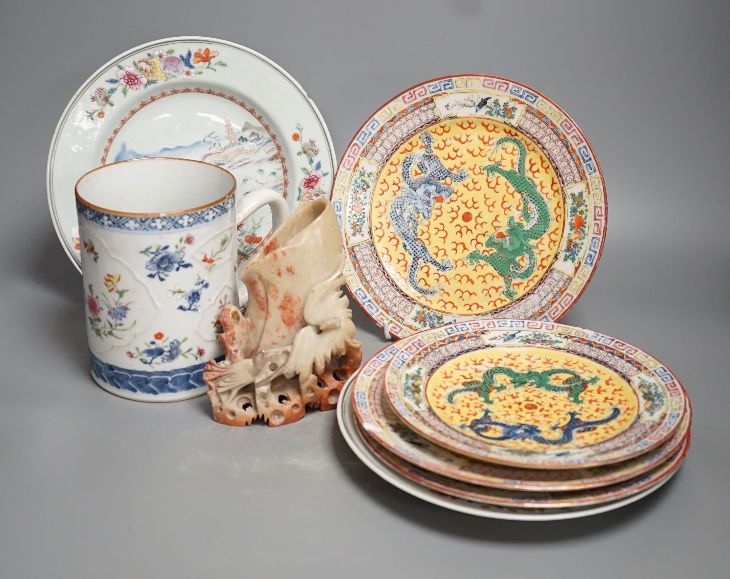 An 18th-century Chinese export mug, 15cm high, two similar plates, four 20th century Chinese dragon plates and a soapstone vase